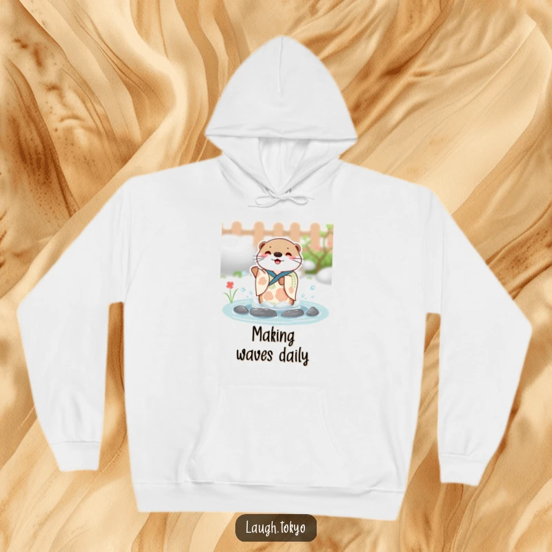 Funny charming otter in a festive kimono splashing with joy in a small pond, printed on a warm and cozy hoodie.