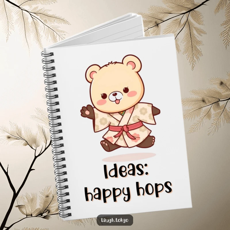 Funny playful bear cub in a patterned kimono doing a happy hop, on the cover of this cute notebook.
